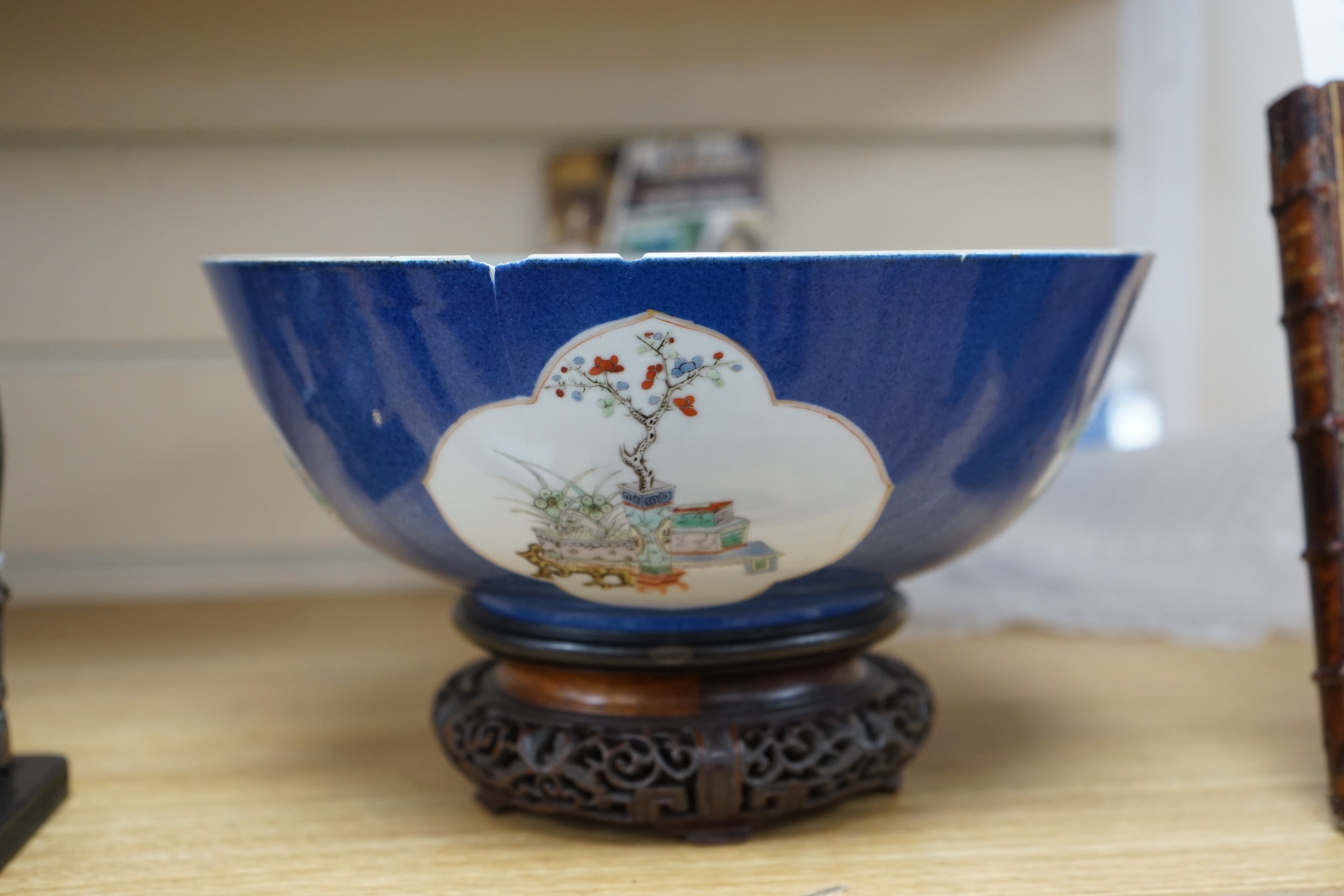 A 19th century Chinese famille verte powder blue bowl, 26cm diameter, wood stand